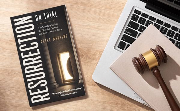 Book on resurrection and a judge's gavel on a laptop.