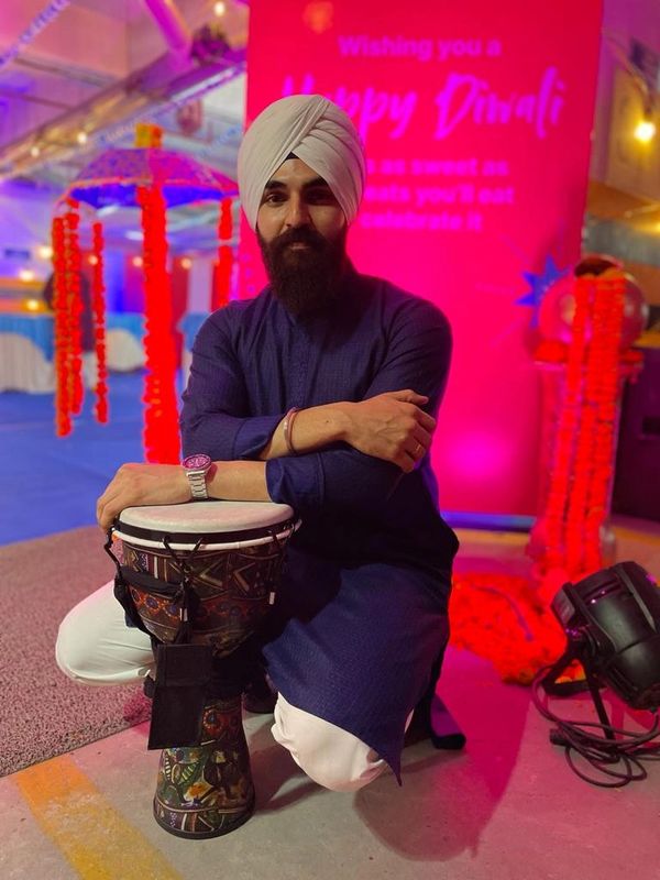 A guy posing with a Djembe after a drum circle