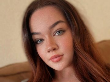 Close-up of a young woman with long brown hair and natural makeup.