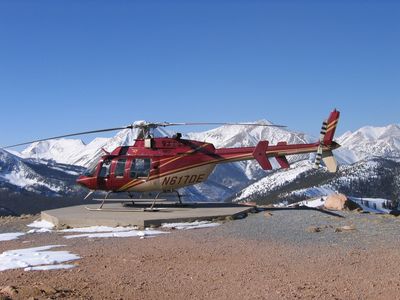 Red helicopter on a snowy mountain