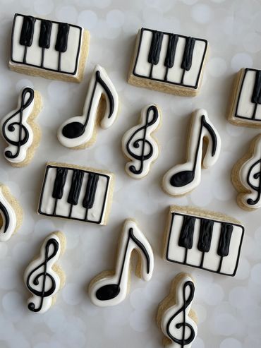 Musical themed sugar cookies with a treble clef, music note and keyboard. 