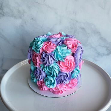 Multi colour piped smash cake. 
