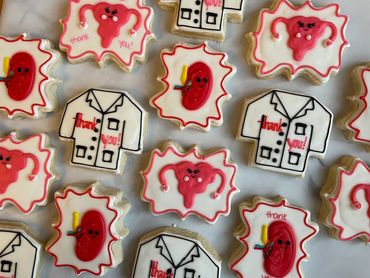 Decorated sugar cookies to thank a urologist including a kidney and lab coat. 