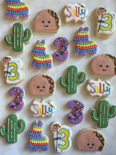 Fiesta themed sugar cookies for a birthday including a taco, cactus and pinata. 