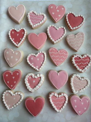 Valentine's sugar cookies in different heart shapes and designs. 