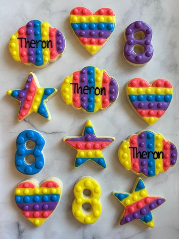 Decorated sugar cookies to look like colourful Pop-Its. 