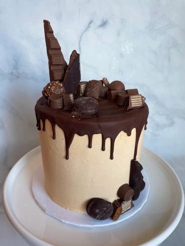 Chocolate drip buttercream cake with chocolate details. 