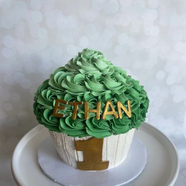 Green ombre giant cupcake smash cake with gold fondant 1 on front. 