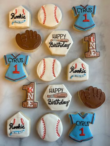 Baseball cookies for a first birthday with a glove, jersey and baseball. 