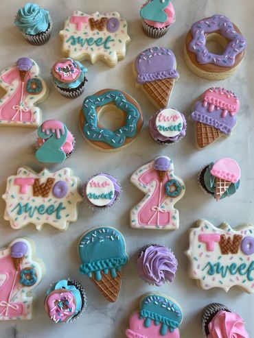 Two Sweet birthday sugar cookies with ice cream and donuts. 