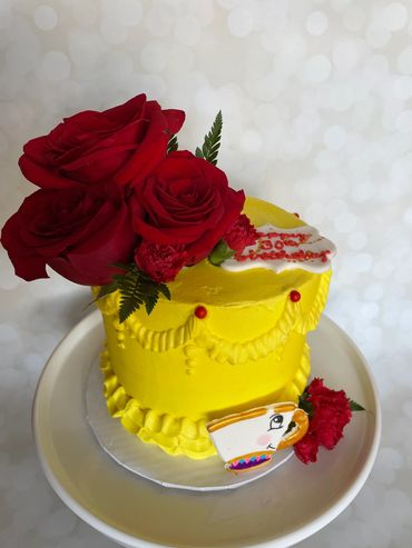 Beauty and the Beast theme cake with real roses and a fondant hand painted teacup. 