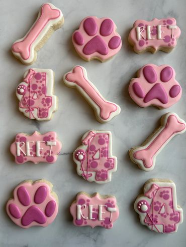 Puppy themed cookies including a paw print and bone. 