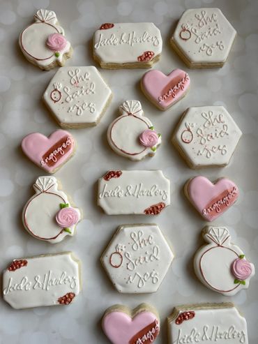 Rose gold engagement cookies with a ring and hearts. 