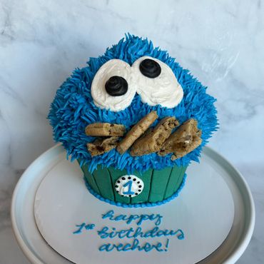 Cookie Monster theme giant smash cupcake for first birthday with real cookies. 