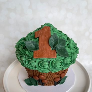 Mushroom and leaf theme giant cupcake smash cake with fondant mushrooms and number 1. 