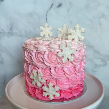 Pink ombre buttercream rosette cake with sparkly fondant snowflakes. 