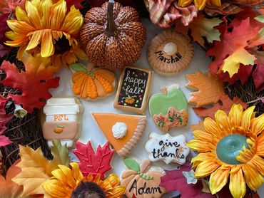 Thanksgiving themed sugar cookies with a caramel apple, pumpkin and pie. 