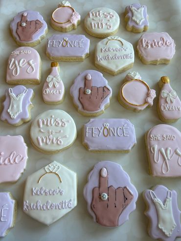 Decorative Beyonce bridal shower cookies with engagement and wedding themes in pastel colors.