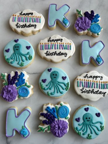 Ocean themed birthday cookies with an octopus, flowers and birthday candles. 