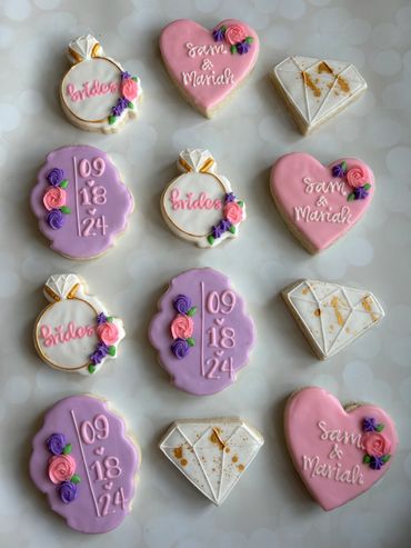 Purple and pink theme engagement cookies with rings, diamonds and hearts. 