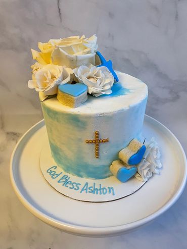 A blue and white ombre buttercream cake with fresh flowers. 