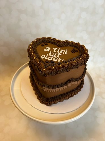 Chocolate heart shape vintage cake with buttercream coffee beans. 