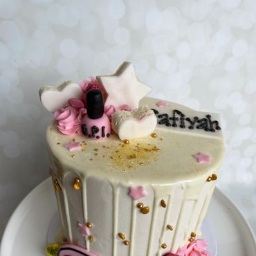 Makeup themed kid's birthday cake with a chocolate drip. 