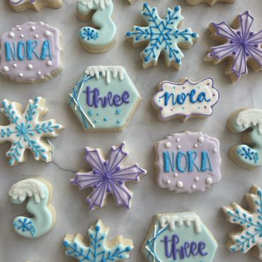 Frozen themed sugar cookies including purple and blue snowflakes. 