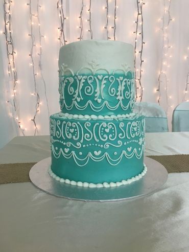 2 tier teal and white ombre buttercream cake with white buttercream piping. 