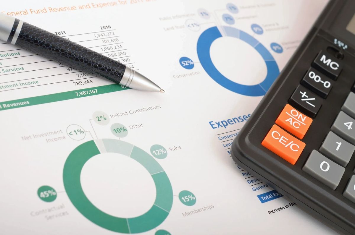 Financial statements, a calculator and a pen on a desk