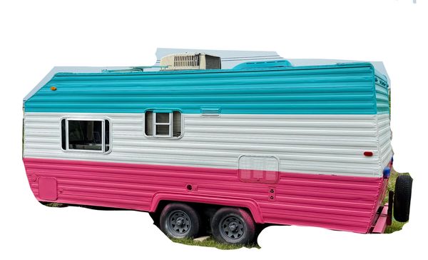 Colorful vintage camper trailer with teal, white, and pink stripes.