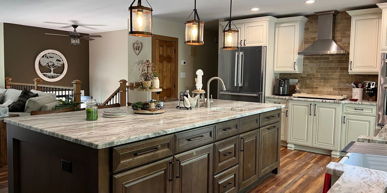 Spacious kitchen with a large marble island and modern lighting.