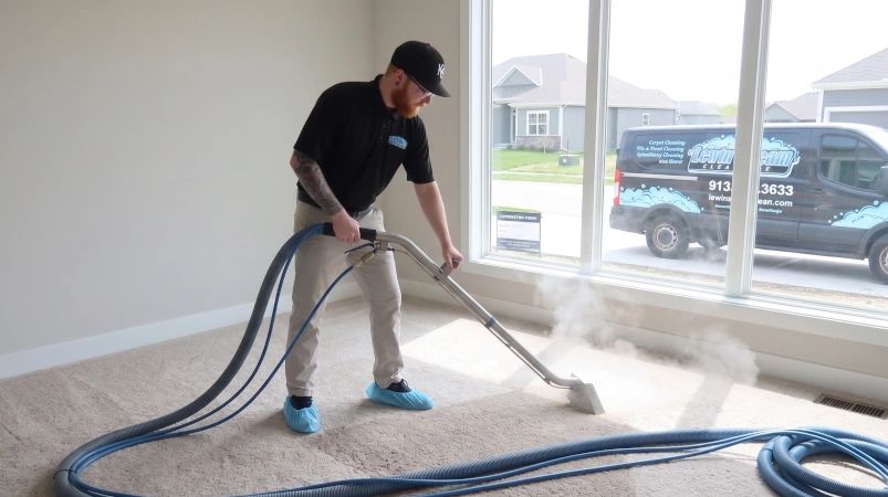 Professional carpet cleaning in progress with steam and specialized equipment.
