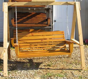 Light colored Porch Swing in free standing frame