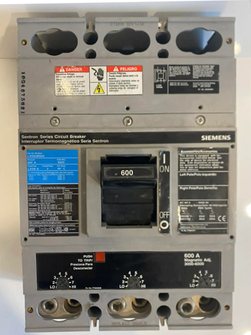 Siemens Sentron Series 600A circuit breaker with warning labels and adjustment dials.