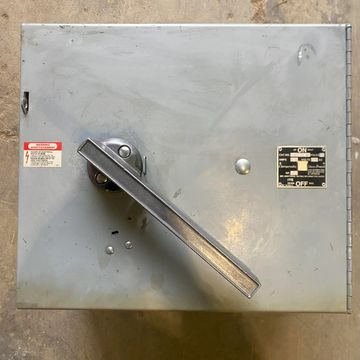 Industrial metal switch box with a large handle.