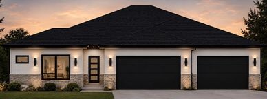 Modern single-story house with three-car garage at sunset.