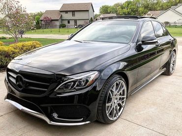 Black Mercedes-Benz parked on driveway.