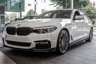 White BMW sedan parked indoors.