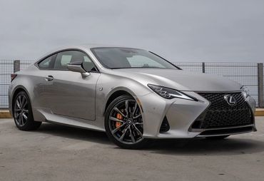Silver Lexus sports car parked outdoors.