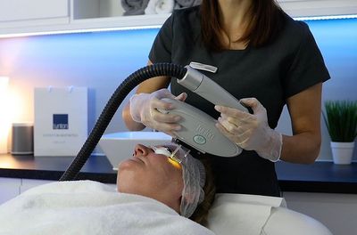 Lynton IPL machine treating someones face.