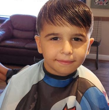 Young boy finished haircut, Bridget Street Barber Shop