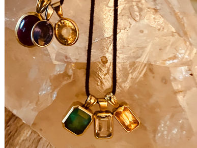 two necklaces with gemstones on them