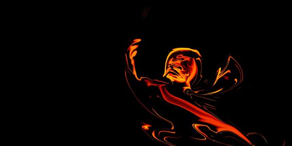 Abstract fiery figure glowing against a dark background.