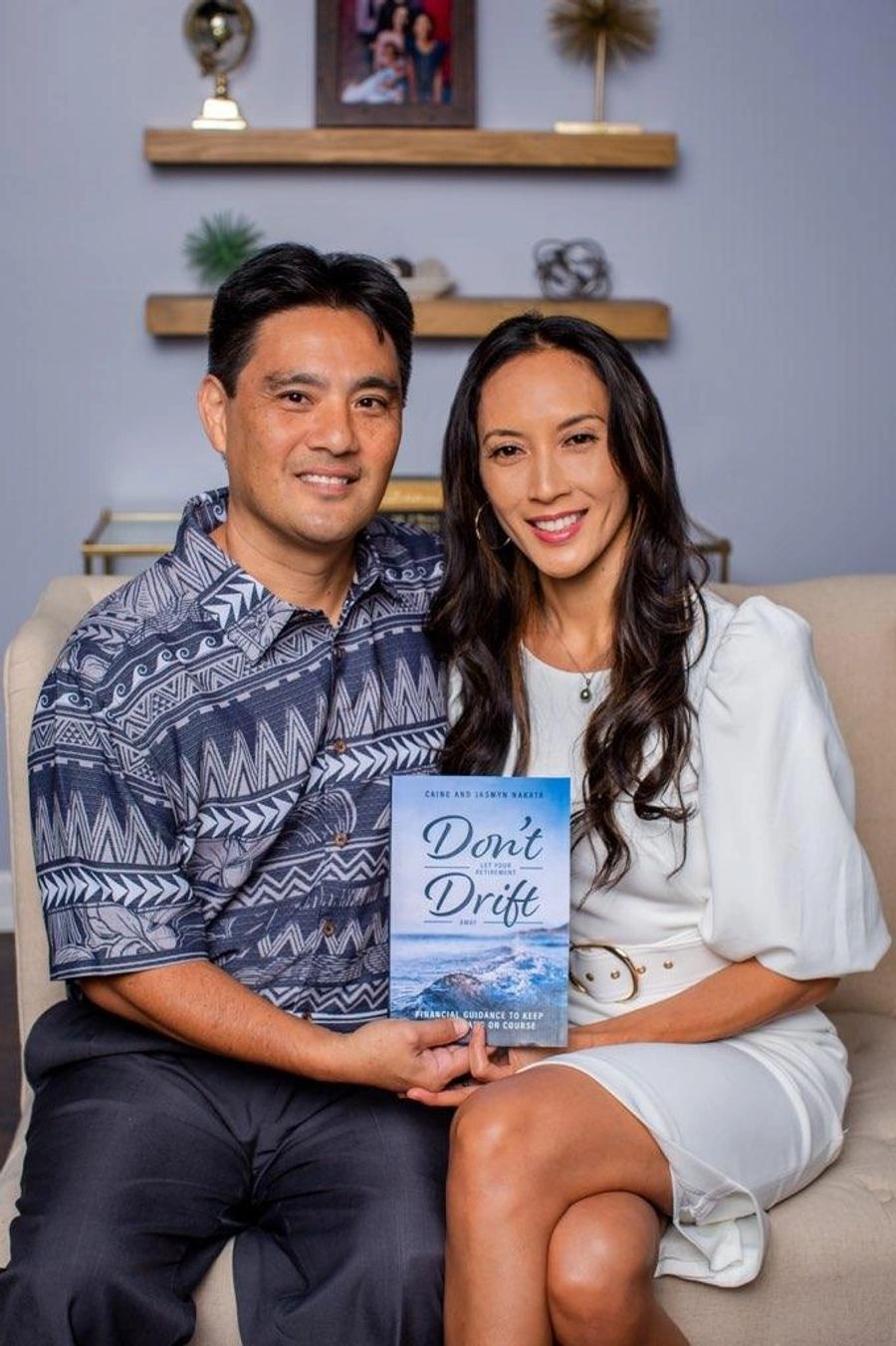 Caine and Jasmyn Nakata holding their retirement planning book, Don't Let Your Retirement Drift Away