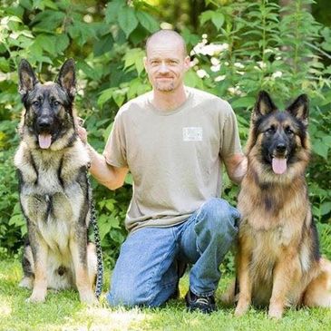 Ted Robbins - The owner of Robbins Plumbing and Heating with two of his German Shepherds