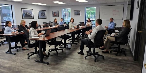 Colleagues in a modern meeting room having a discussion.