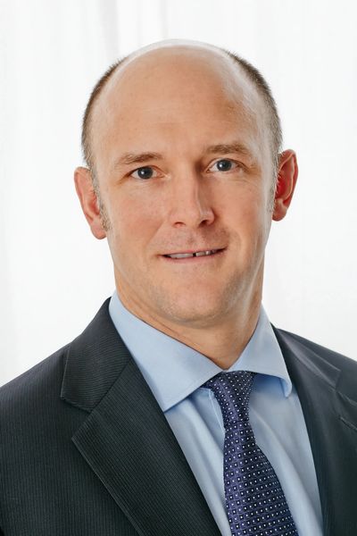 Professional man in suit and tie with a confident expression.