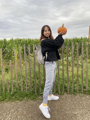 A woman holding a pumpkin