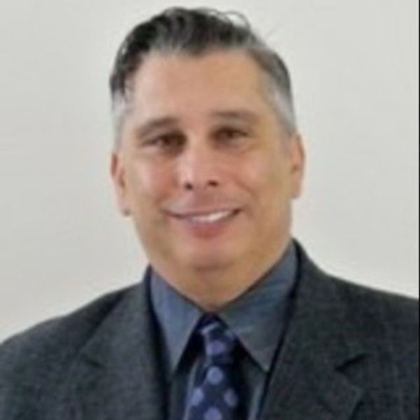 Professional man in suit smiling at the camera.